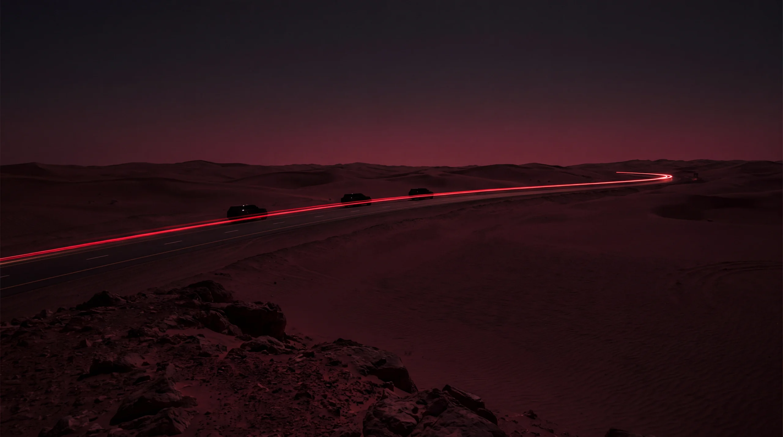 An illuminated private route through the desert at night